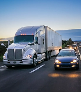 A truck and cars down the highway